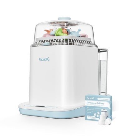 White and blue sterilizer with toys inside and a box of detergent tablets on a white background