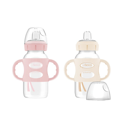 Two baby bottles with pink and beige handles on a white background