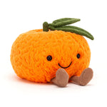 Plush toy pumpkin with a smiling face on a white background