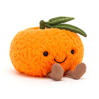 Plush toy pumpkin with a smiling face on a white background