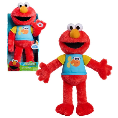 Red plush toy with a blue shirt featuring fish designs, next to its packaging on a white background.
