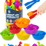 Colorful children's toy set with sorting bowls and toys, including a hand using tongs.