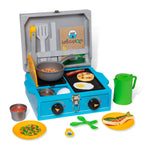 Toy kitchen set with stove, pots, and utensils on a white background