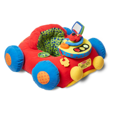 Colorful toy car with buttons and a steering wheel on a white background