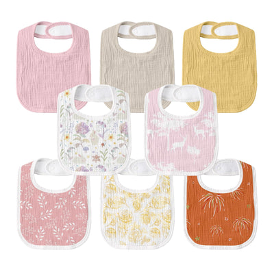 Set of colorful baby bibs with floral patterns on a white background