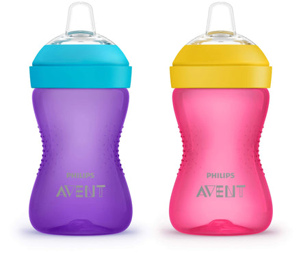 Two Philips Avent sippy cups, one purple with a blue lid and one pink with a yellow lid, on a white background.