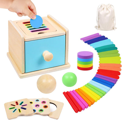 Colorful educational toys including a wooden box with colorful shapes, a stack of rainbow-colored cups, and a set of wooden balls.