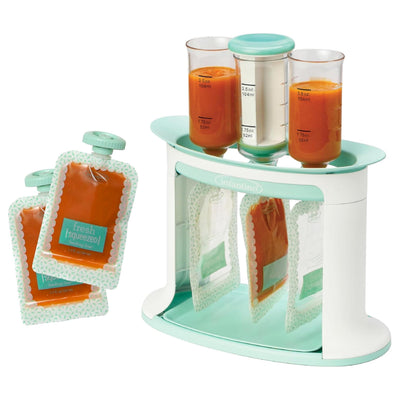 Organized display of baby food pouches and containers with orange juice on a white background