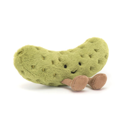 Plush pickle toy with a smiling face on a white background