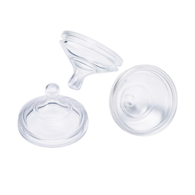 Three clear silicone baby bottle nipples on a white background