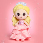 Plush toy of a princess with blonde hair and a pink dress on a pink background