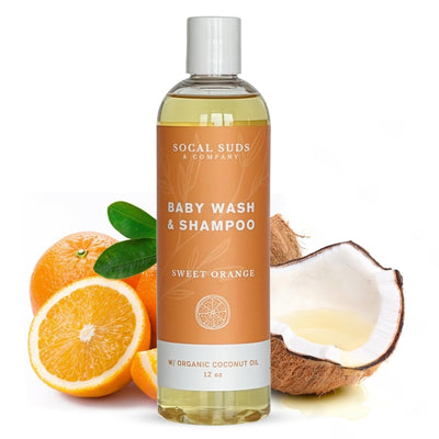 Baby wash and shampoo bottle with oranges and coconut on a white background