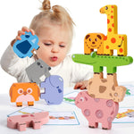 Child playing with colorful animal-shaped wooden toys on a white surface.