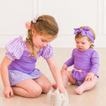 RuffleButts Baby Girls UPF50+ Princess Long Sleeve Bow Skirted One Piece Swimsuit - Amethyst Princess, 18-24m