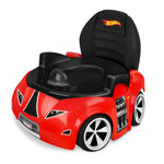 Red car-shaped potty chair with black seat and Hot Wheels logo on a white background