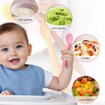 Baby eating with various food textures displayed around
