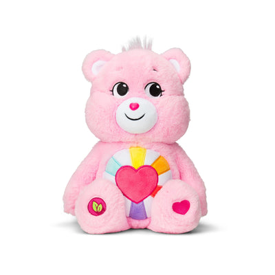 Pink plush toy with a heart on a white background