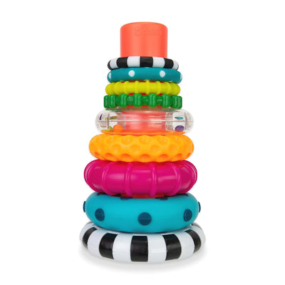 Stack of colorful baby rings with different textures and patterns on a white background