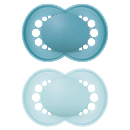 Two blue silicone pacifiers on a white background