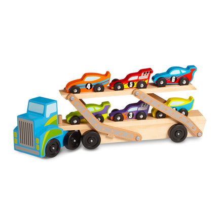 Wooden toy truck with trailer carrying smaller toy cars on a white background