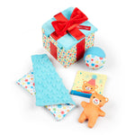 Collection of baby toys and a gift box with a red bow on a white background