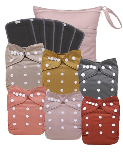 Set of baby cloth diapers with polka dot patterns and bows in various colors.
