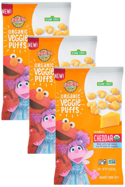 Four packages of Organic Veggie Puffs with Sesame Street characters on a white background