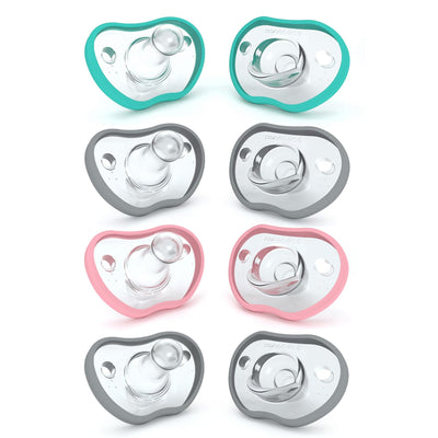 Set of eight baby pacifiers in different colors on a white background
