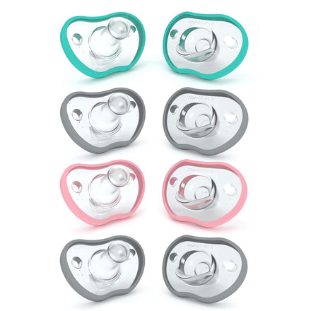 Set of eight baby pacifiers in different colors on a white background