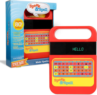 Red and yellow 'Speak & Spell' toy with packaging on a white background