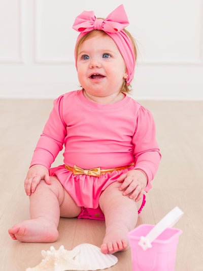 RuffleButts Baby Girls UPF50+ Princess Long Sleeve Bow Skirted One Piece Swimsuit - Royal Pink Princess, 12-18m
