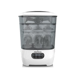 White and clear sterilizer with baby bottles inside on a white background