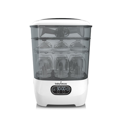 White and clear sterilizer with baby bottles inside on a white background