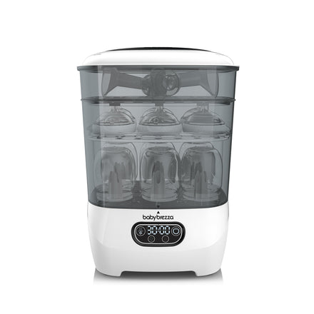 White and clear sterilizer with baby bottles inside on a white background