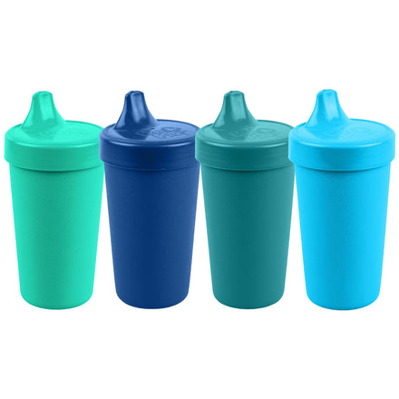 Four colorful sippy cups on a white background