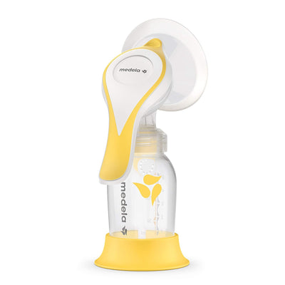 Yellow and white Medela breast pump on a white background