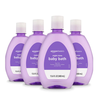 Four bottles of Amazon Basics night time baby bath on a white background
