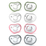 Set of eight baby pacifiers in green, white, and pink on a white background