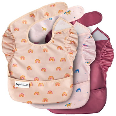 Set of baby bibs with rainbow pattern and pink coverall on a white background