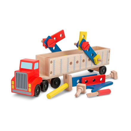 Wooden toy truck with detachable tools on a white background