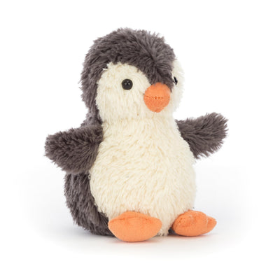 Stuffed penguin toy with gray fur, white belly, and orange feet and beak on a white background
