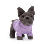 Stuffed dog toy wearing a purple sweater on a white background