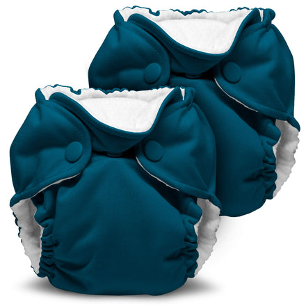 Two blue cloth diapers with white interiors on a white background