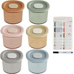 Set of colorful containers with lids and a marker on a white background