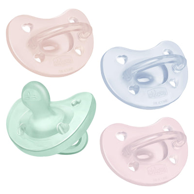 Four pastel-colored baby pacifiers on a white background