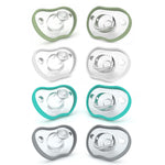 Set of baby pacifiers with green, gray, and teal borders on a white background
