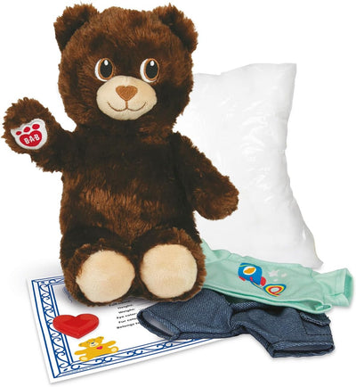 Plush teddy bear with accessories including a pillow, underwear, and a card on a white background