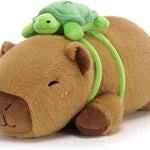 Plush toy hippo with a green turtle on its back on a white background