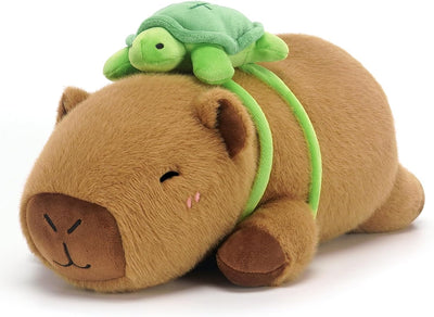 Plush toy hippo with a green turtle on its back on a white background