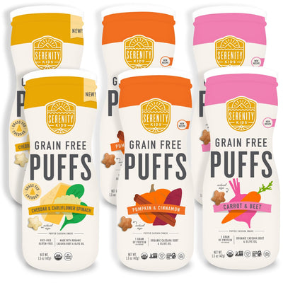 Three packages of Serenity Kids grain-free puffs with different flavors on a white background.